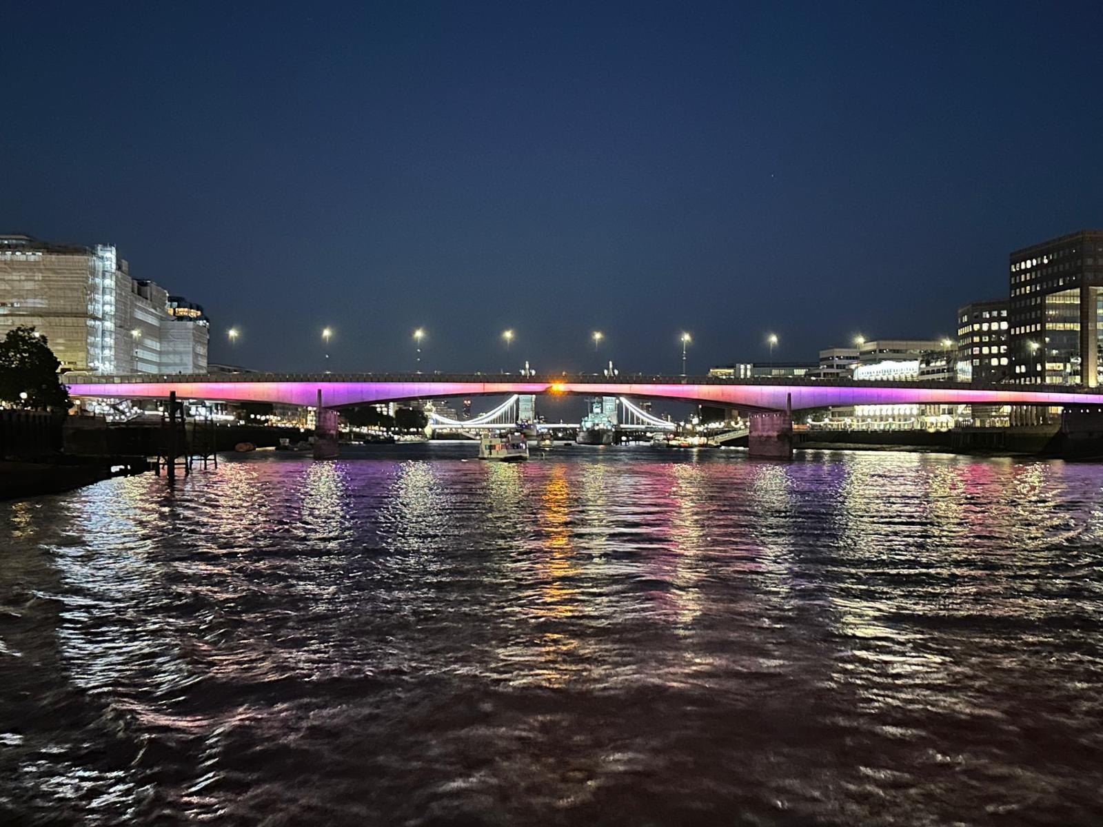 London Bridge lit at night, with Tower Bridge beyond